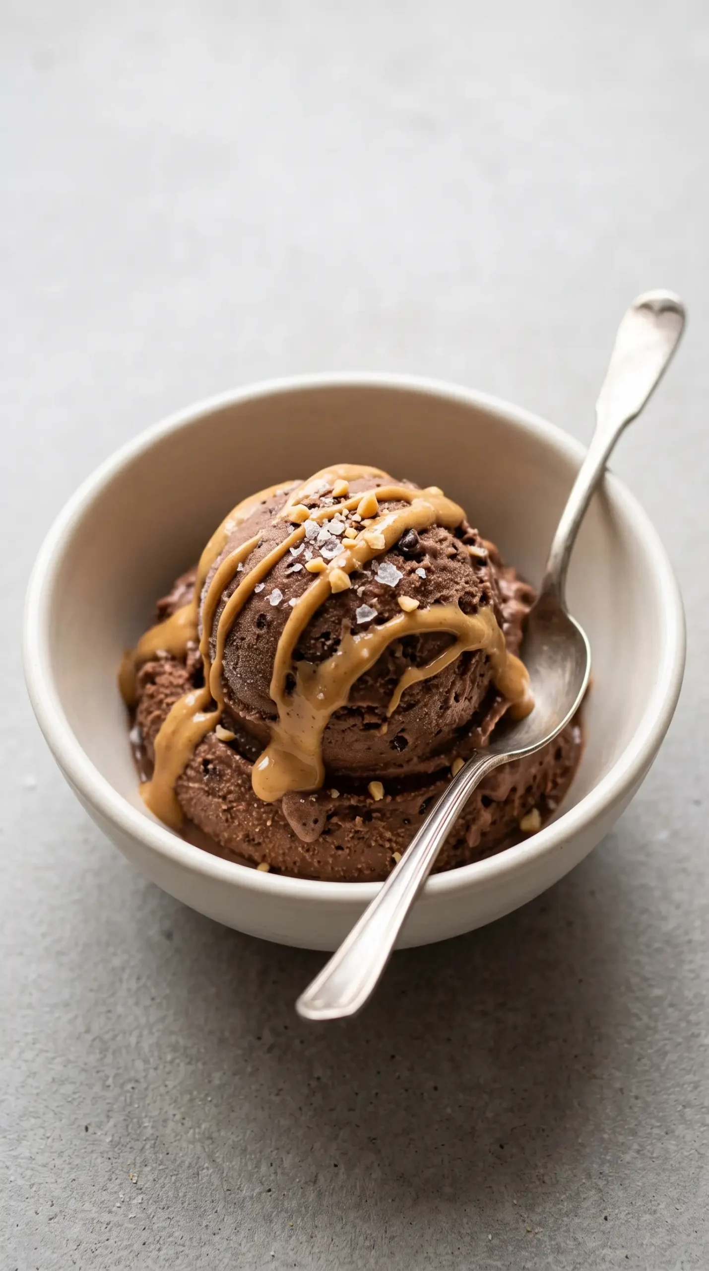 Chocolate banana ice cream topped with peanut butter drizzle and sea salt