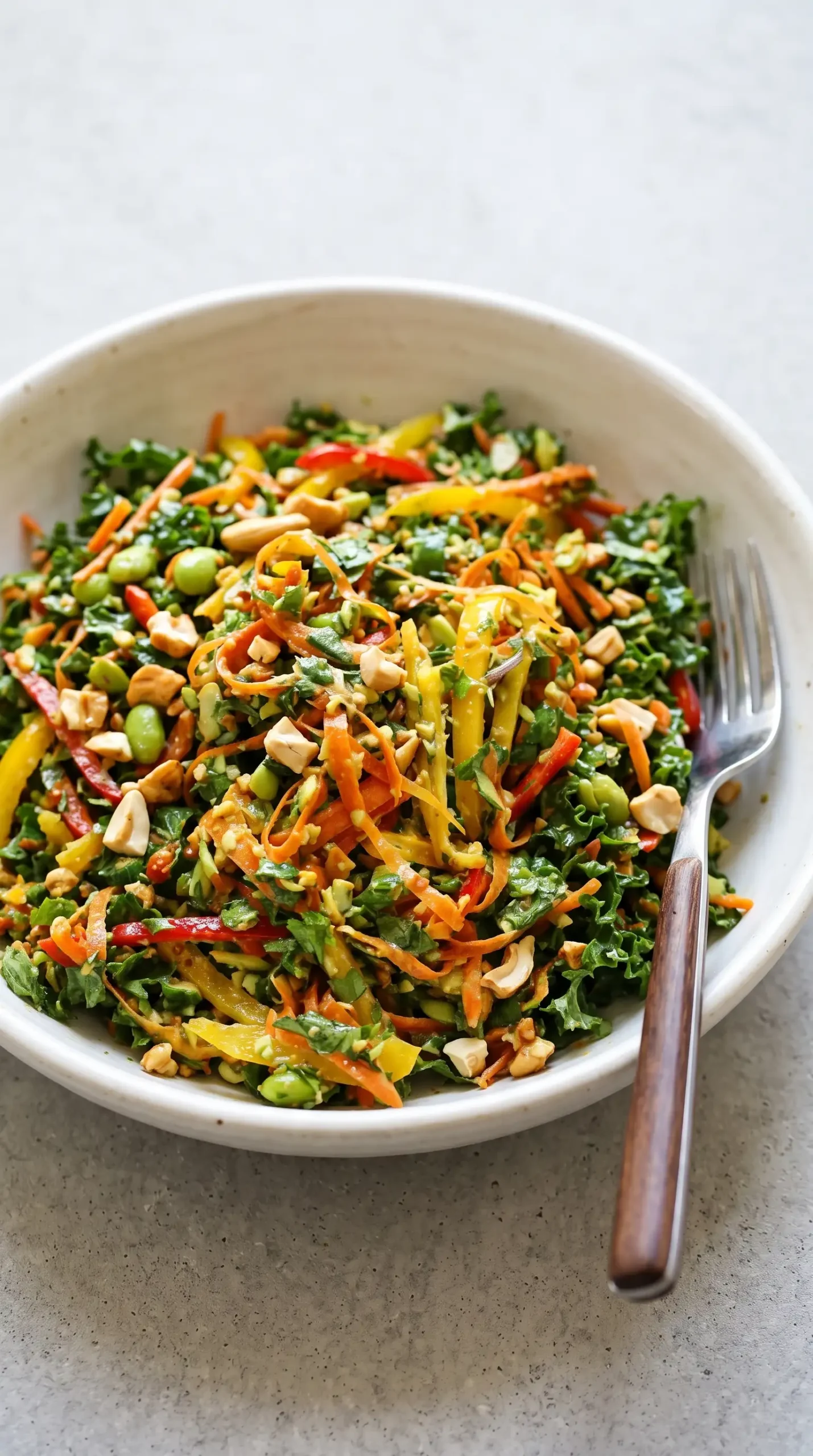 Finished chopped Thai salad with kale, peppers, edamame, herbs, and cashews