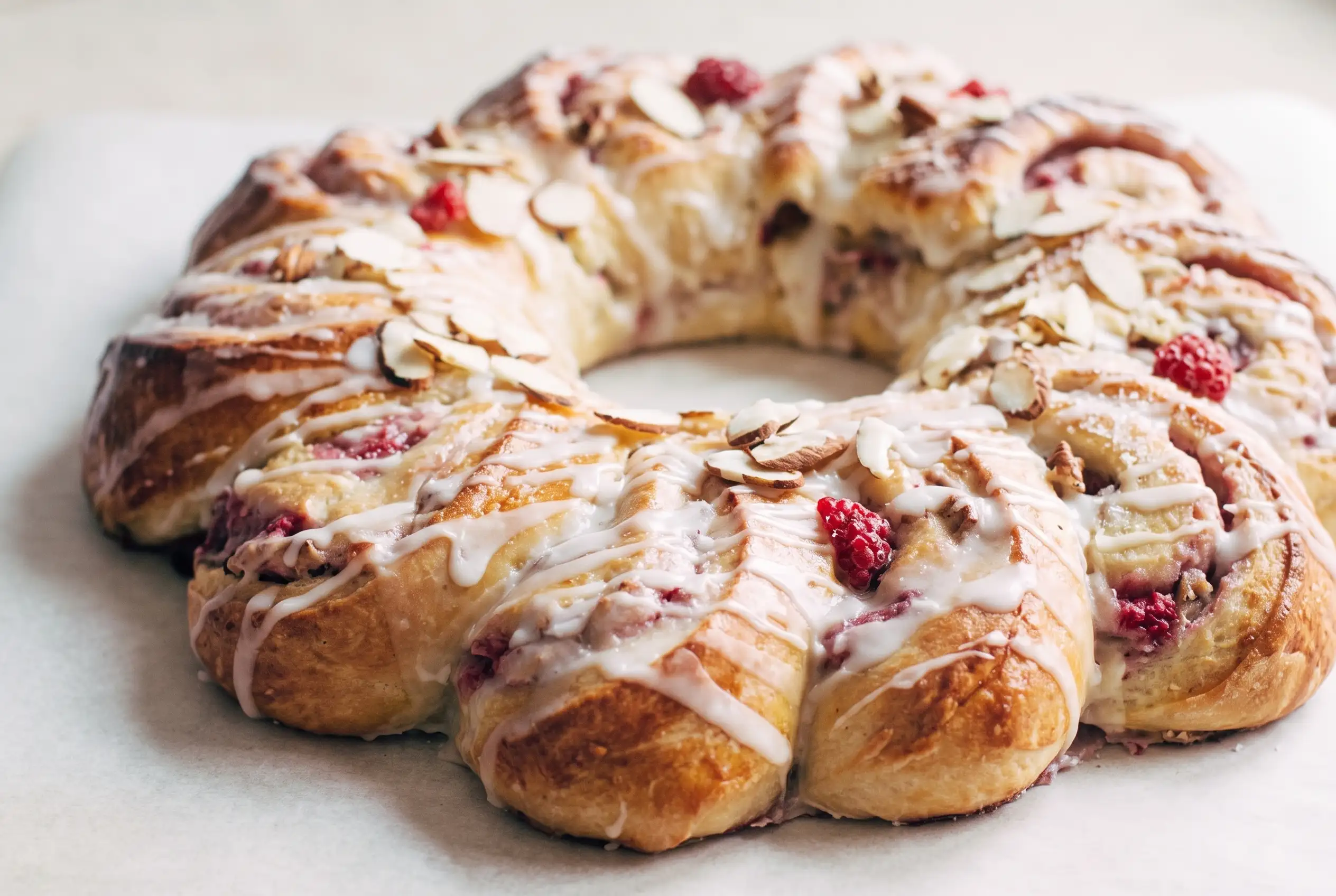 Christmas tea ring with raspberry cream cheese filling and powdered sugar glaze