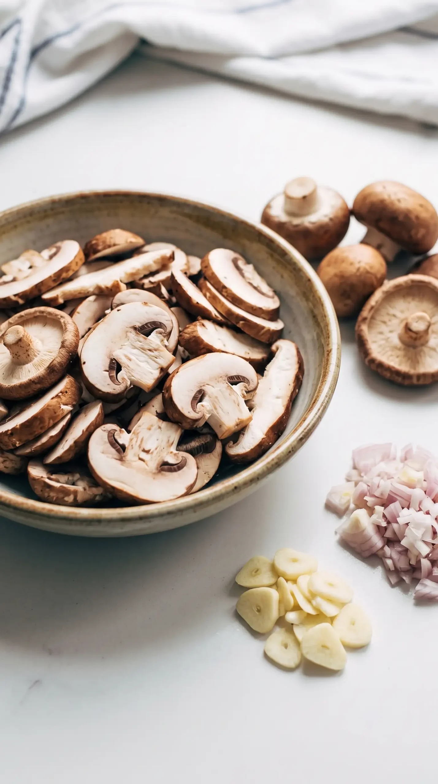 Sliced cremini and shiitake mushrooms with garlic and shallots for pasta sauce