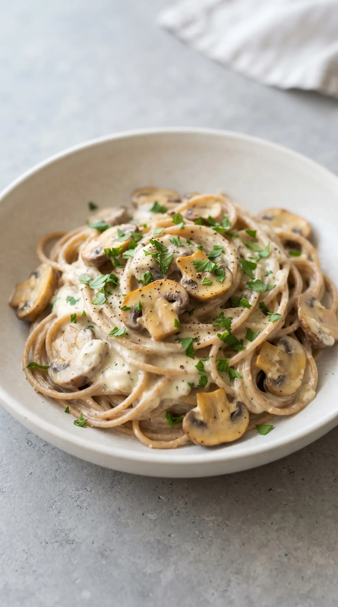 Garlic herb mushroom spaghetti with creamy sauce, sautéed mushrooms, and fresh parsley