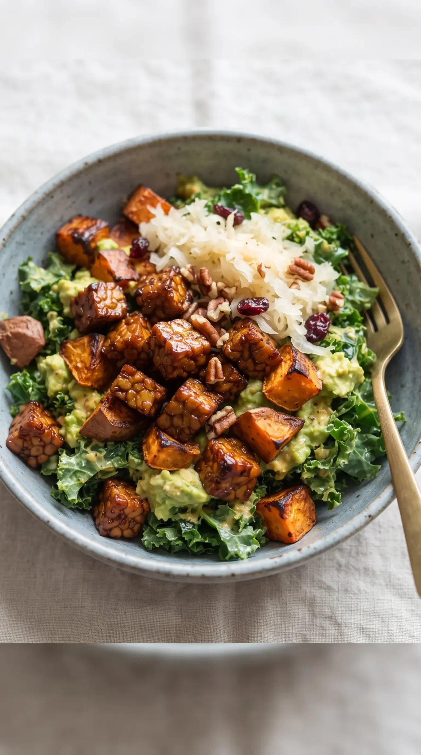 Finished bowl with maple mustard tempeh, roasted sweet potatoes, kale, and sauerkraut