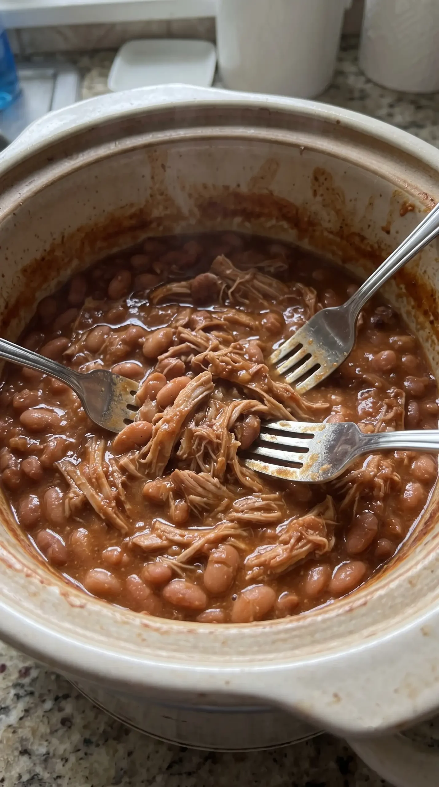Slow cooker pork shoulder and pinto beans mixed into a thick chili-seasoned chalupa filling