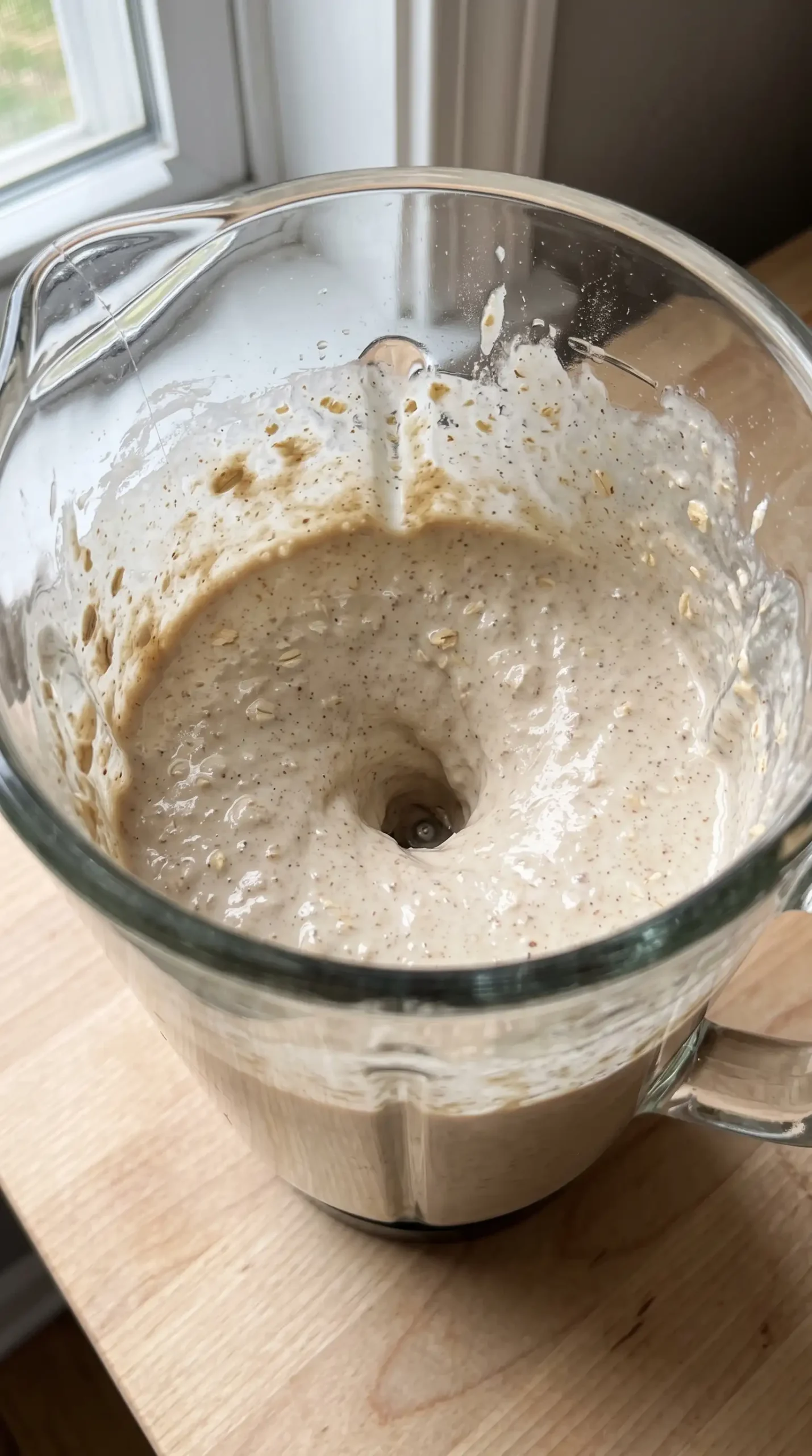 Blender filled with smooth whole grain pancake batter made with cottage cheese and oats